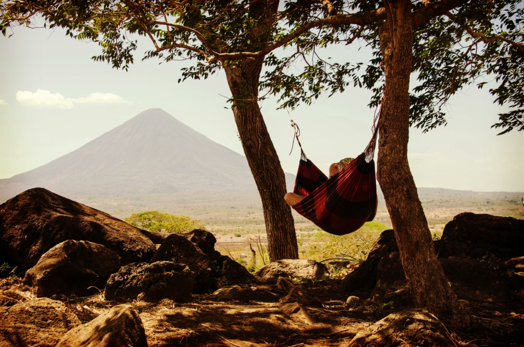 Woman enjoying the view of a volcano in Nicaragua, Central America